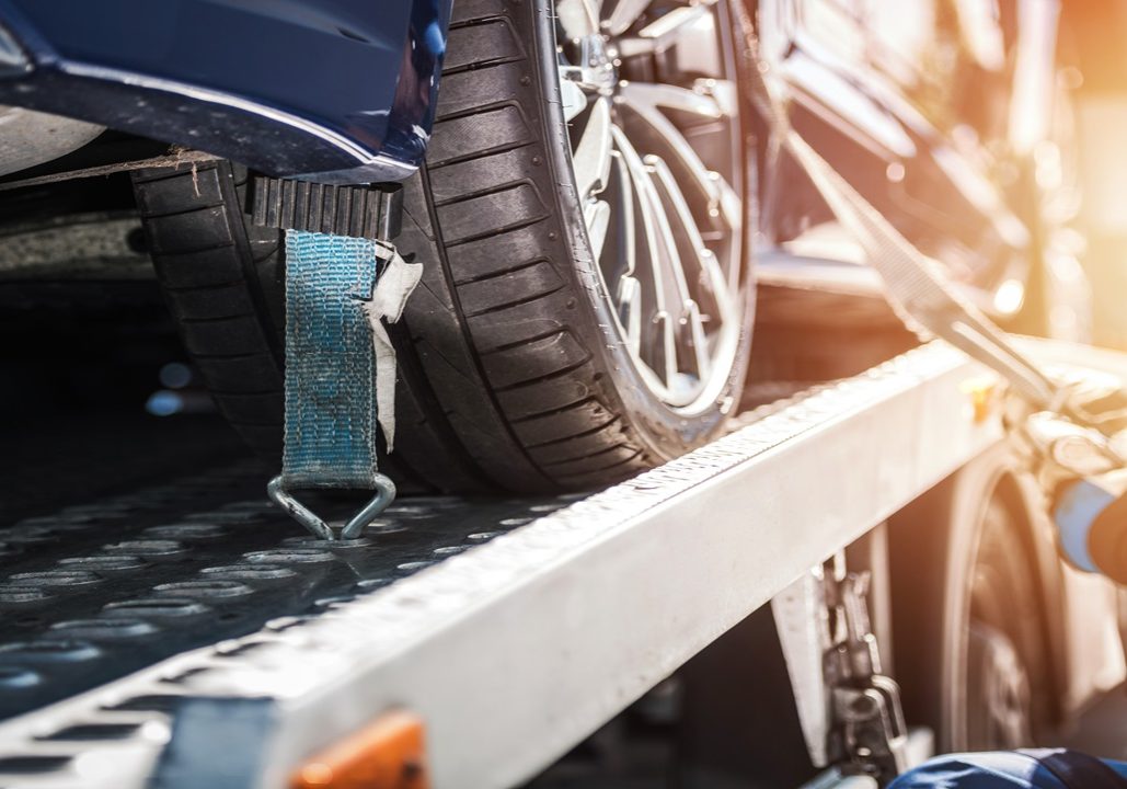 Car Safely Fastened On Towing Truck Car Safely Fastened On Towing Truck